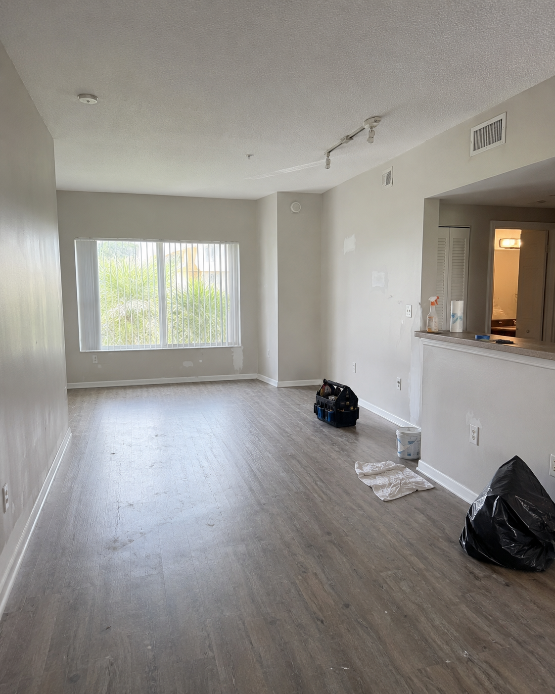 Vacant unit with wall patches, debris, and final prep items pending.